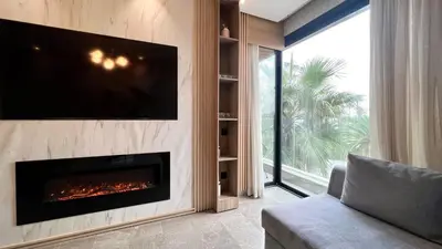 a living room with a fireplace and a tv at The Address - Sunny Anfa Hills in Casablanca