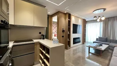 a kitchen and a living room with a couch at The Address - Sunny Anfa Hills in Casablanca