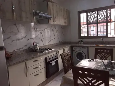 a kitchen with a sink and a stove top oven at Airport M V chambre stay in Deroua