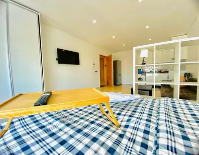 a room with a bed with a remote control on it at Quiet Top-Floor Studio by Med Faculty & Tram Lines in Casablanca