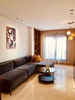 a living room with a couch and a table at Chic Palmier - heart of town in Casablanca