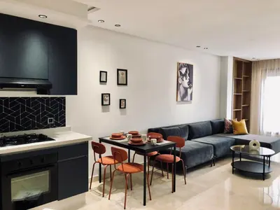 a living room with a couch and a table at Chic Palmier - heart of town in Casablanca