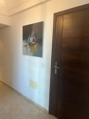 a painting on a wall next to a door at Camilia Appart 2P TGV in Rabat