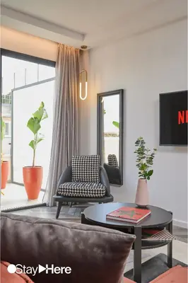 a living room with a couch and a table at Stayhere Rabat - Agdal 4 - Hotel in Rabat