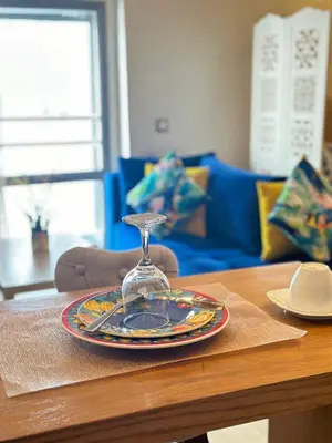 a table with a glass plate on a wooden table at Appartement confortable et pas cher au parc in Mohammedia