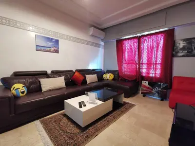 a living room with a couch and a table at Blume Apartment Casa Port - 2 Bedrooms in Casablanca