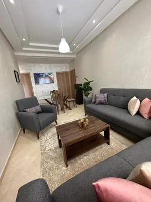 a living room with couches and a coffee table at Apparemment de luxe Bouznika in Bouznika