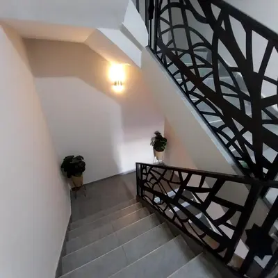 a stairway with two potted plants on it at appartement moderne proche aéroport in Derroua