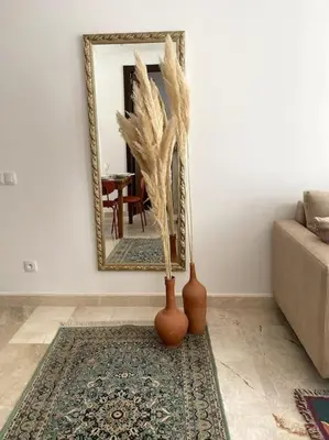 two vases sitting on a rug in front of a mirror at Jade - Appartement Luxe - Casablanca in Casablanca