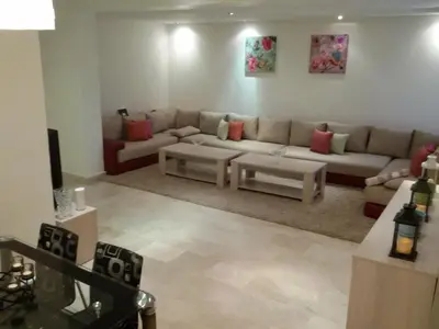 a living room with a couch and a table at Stylish Property Perfect for Business & Leisure Trips in Casablanca