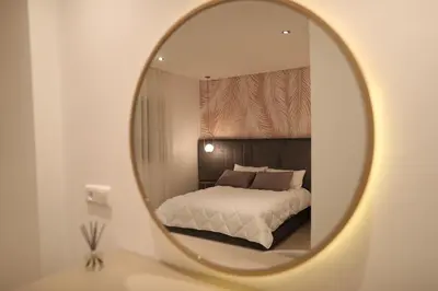 a bedroom with a bed and a mirror on a table at Cozy Apartment with Veranda Downtown in Casablanca