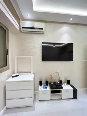 a living room with a flat screen tv on the wall at L'Appartement Harmonia Cozy in Casablanca