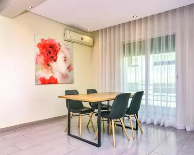 a dining room with a table and chairs at Cozy Central - Gym & Spa Srvcs in Casablanca