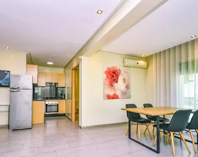 a kitchen and dining room with a table and chairs at Cozy Central - Gym & Spa Srvcs in Casablanca