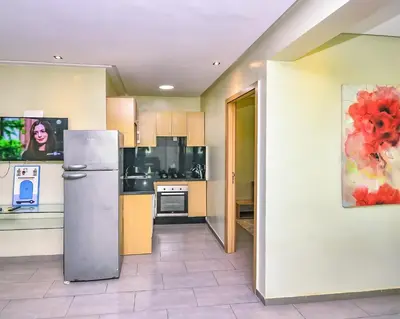 a kitchen with a stainless steel refrigerator in a room at Cozy Central - Gym & Spa Srvcs in Casablanca