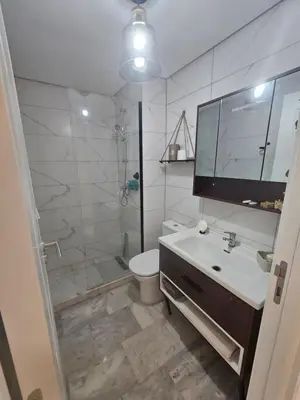 a bathroom with a shower and a sink and a toilet at Airport Break in Nouaceur