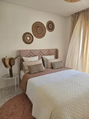 a bedroom with a large bed with hats on the wall at Airport Break in Nouaceur