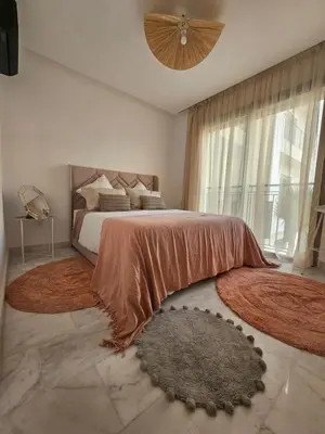 a bedroom with a large bed and a large window at Airport Break in Nouaceur