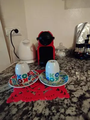 two cups and saucers on a counter with a coffee maker at Magnificent Sunlit Ground-Floor Apartment Netflix,Wi-Fi ,Comfort, Style in Casablanca