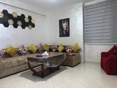 a living room with a couch and a table at Magnificent Sunlit Ground-Floor Apartment Netflix,Wi-Fi ,Comfort, Style in Casablanca