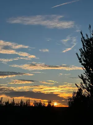 a cloudy sky at sunset with a tree in the foreground at Ecolodge Vert, Benslimane in Oulad Youssef