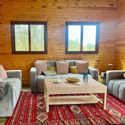 a living room with a couch and a table at Ecolodge Vert, Benslimane in Oulad Youssef