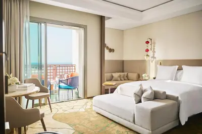 a bedroom with a bed and a living room at Four Seasons Hotel Rabat at Kasr Al Bahr in Rabat