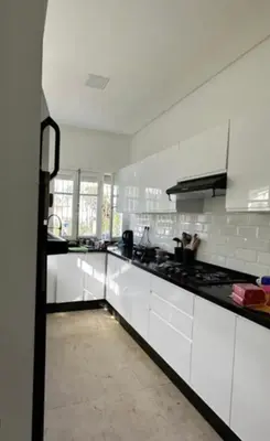 a large white kitchen with white counters and appliances at Villa entière Dar Baida Plage David Bouznika in Bouznika