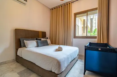 a bedroom with a large bed and a window at AeroSerenity in Nouaceur