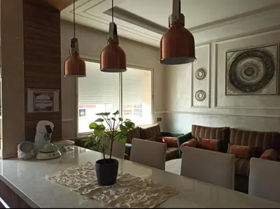 a kitchen with two pendant lights and a living room at home & room center of rabat in Rabat
