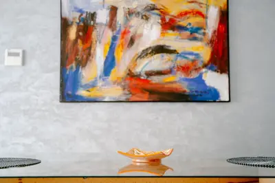 a painting on a wall with a vase on a table at Luxurious Close to all attractions in Casablanca