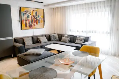 a living room with a couch and a glass table at Luxurious Close to all attractions in Casablanca