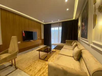 a living room with a couch and a flat screen tv at Corniche Casablanca- Golden Hour in Casablanca