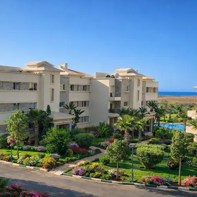 an apartment building with a garden in front at Appart Residence Haut Standing in Bouznika