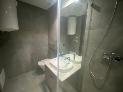 a bathroom with a toilet and a sink and a shower at Hilbert Princesses - Furnished apartments in Casablanca