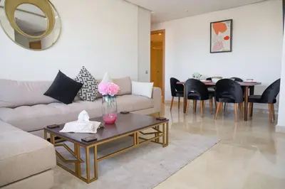 a living room with a couch and a table at Magnificient Appartment in Prestigia in Rabat