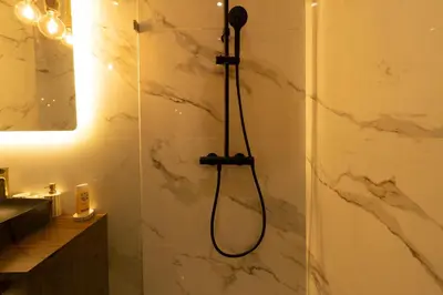 a shower with a shower head in a bathroom at Maarif princess amazing one bedroom flat in Casablanca