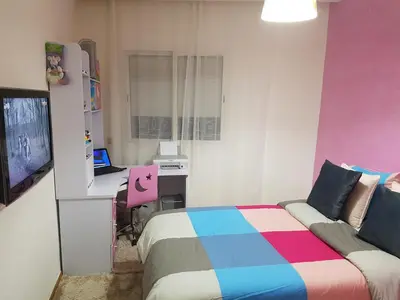 a bedroom with a bed and a desk with a laptop at High-End Apartment with Terrace in Val Fleuri, Maarif Casablanca, Ideal for Families & Business Travelers in Casablanca