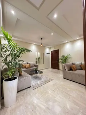 a living room with two couches and a table at SUITOUISS - Agdal 1 - Appartement à 2 minutes de la gare de train TGV Rabat in Rabat