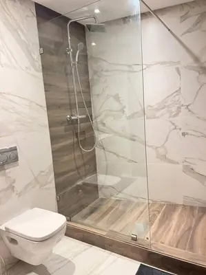 a bathroom with a shower and a toilet at Appartement CFC - Aeria mall in Casablanca