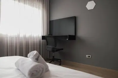 a bedroom with a desk and a bed with towels at Beautifully Designed 3BR Apartment+ Panoramic View in Rabat