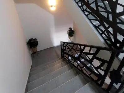 a stairway with two potted plants on the wall at top apartment Airport Mohamed 5 in Derroua