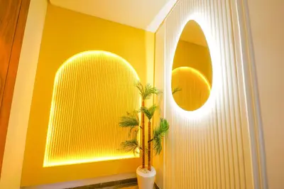 a yellow wall with a palm tree in a room at ROYAL ANFA PARK SUITE-BY AYLA STAY in Casablanca