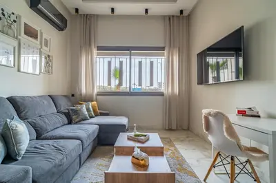 a living room with a couch and a table at AeroSuite in Nouaceur