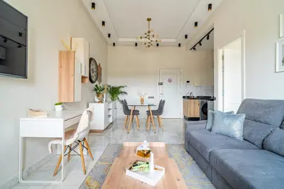 a living room with a couch and a table at AeroSuite in Nouaceur