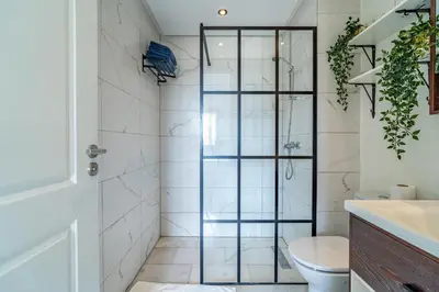 a bathroom with a shower and a toilet at AeroSuite in Nouaceur