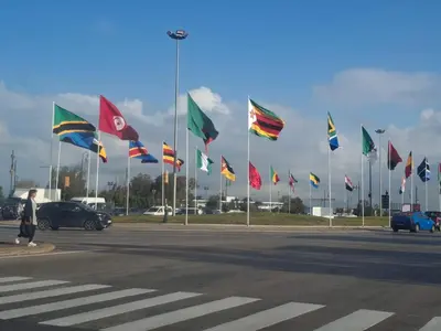 a bunch of flags on poles in a parking lot at Spacieux et familial à 2 minutes à pied du stade de football de RABAT in Rabat