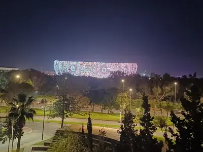 a lit up sign in a park at night at Spacieux et familial à 2 minutes à pied du stade de football de RABAT in Rabat