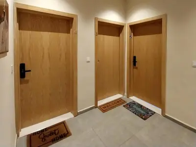 a hallway with two doors and a tile floor at Airport mohamed 5 break apartments in Derroua