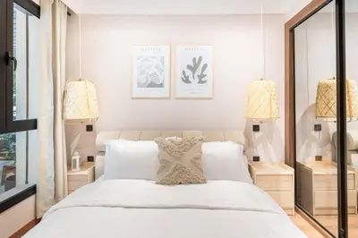 a bedroom with a large white bed with two lamps at TTHOLIDAYS Cosy Apartment Casablanca City Center in Casablanca